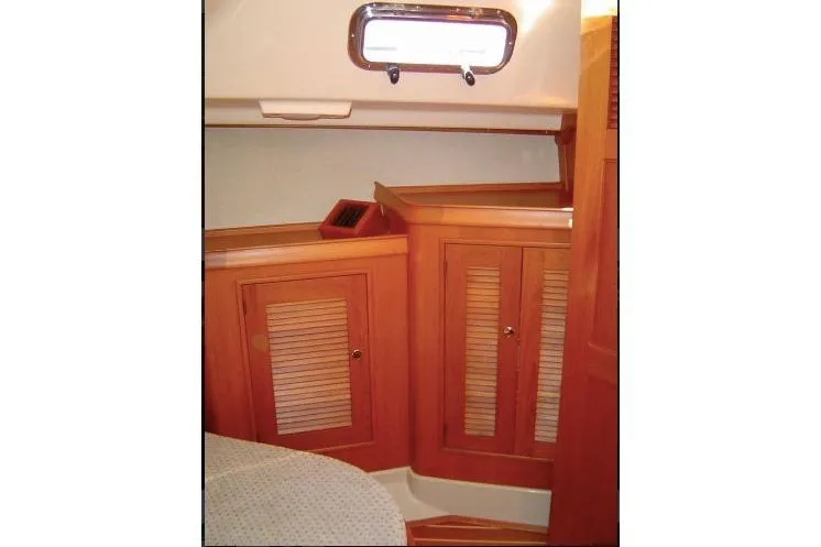 Slide: The Image of 2002 Island Packet Packet Craft Express 360 cabin interior with wooden cabinetry and porthole. - 29