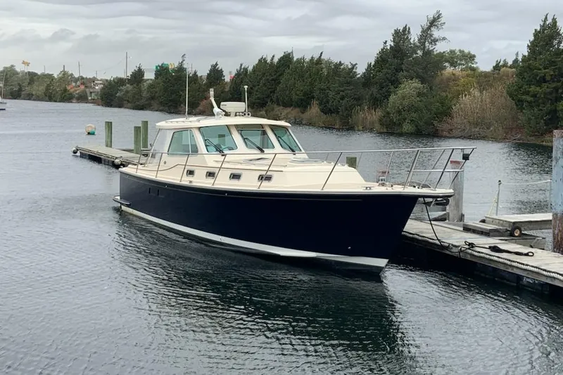 Slide: The Image of 2002 Island Packet Packet Craft Express 360 docked on a calm waterway. - 3