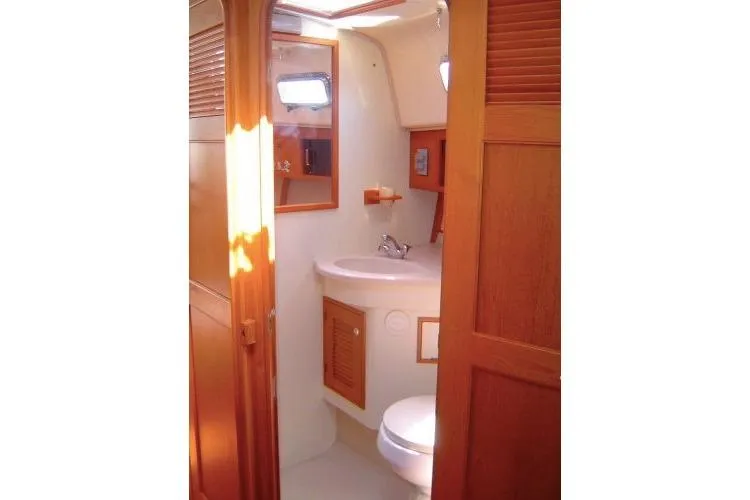 Slide: The Image of 2002 Island Packet Packet Craft Express 360 bathroom with wooden cabinetry and compact design. - 36