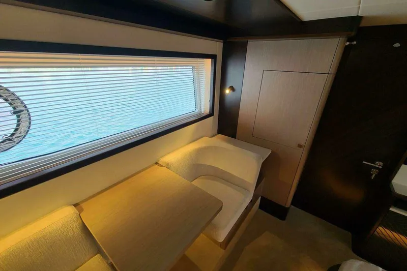 Slide: The Image of Luxurious interior of 2023 Sunseeker Manhattan 68 yacht with elegant seating and window view. - 25