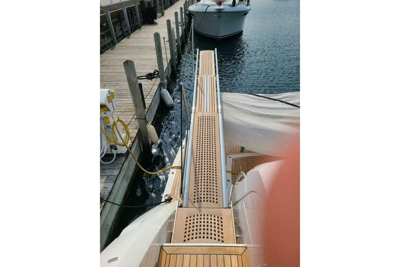 Slide: The Image of 2023 Sunseeker Manhattan 68 yacht docked with wooden gangway and marina view. - 41