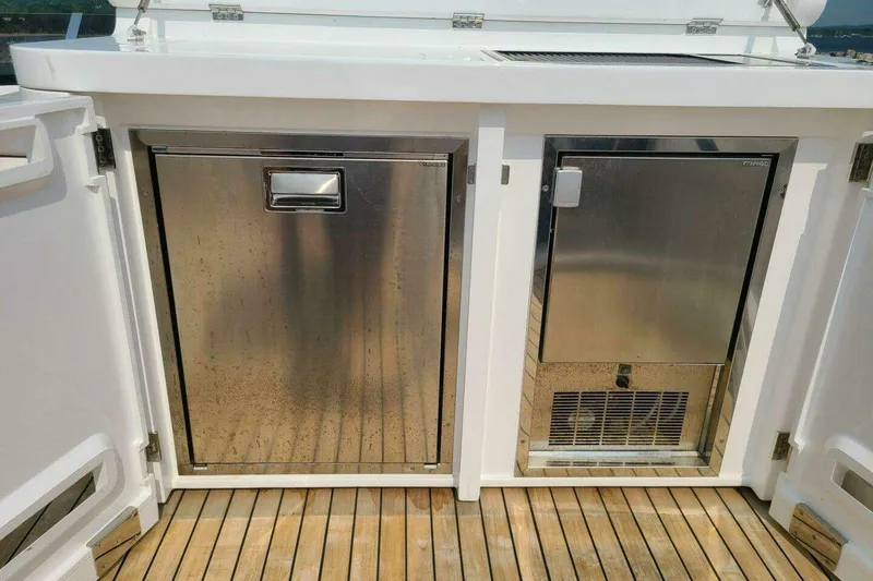 Slide: The Image of Stainless steel appliances on Sunseeker Manhattan 68 yacht, 2023 model, with wooden deck. - 44