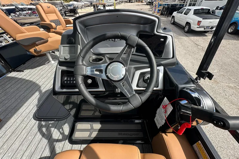 Slide: The Image of 2026 Ranger Reata 223FC boat dashboard with steering wheel and controls. - 11