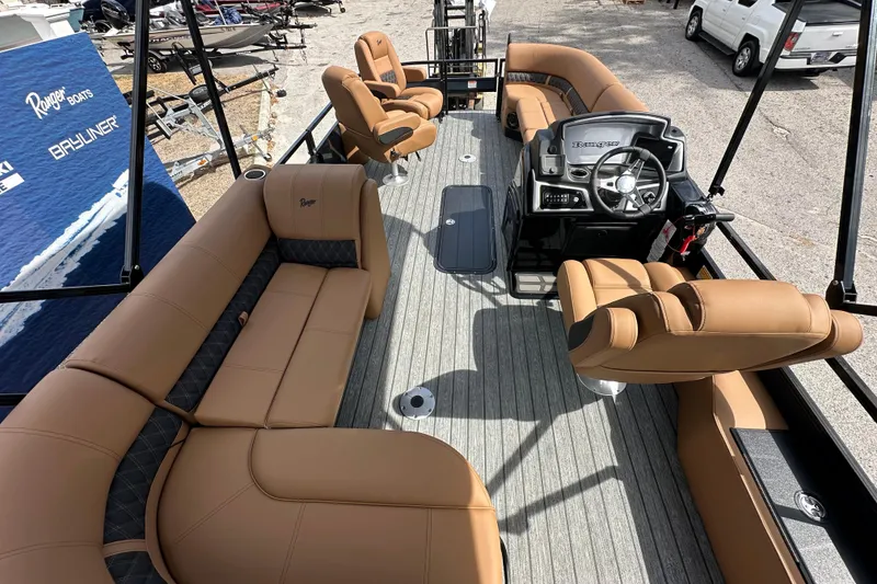 Slide: The Image of 2026 Ranger Reata 223FC boat interior with tan seating and modern steering console. - 14