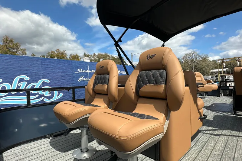 Slide: The Image of 2026 Ranger Reata 223FC boat with luxurious tan seating under a canopy. - 17
