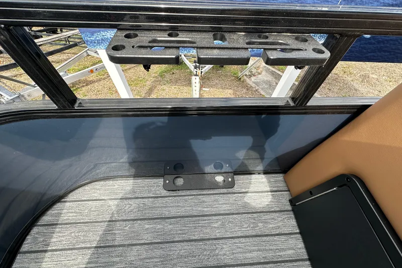 Slide: The Image of 2026 Ranger Reata 223FC boat interior with rod holder and seating area. - 21