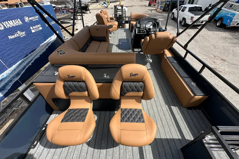 Slide: The Image of 2026 Ranger Reata 223FC boat interior with tan and black seating, steering console, and spacious layout. - 22