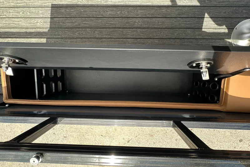 Slide: The Image of Open storage compartment on 2026 Ranger Reata 223FC boat, featuring secure latches and organized interior. - 24