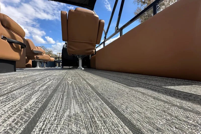 Slide: The Image of 2026 Ranger Reata 223FC boat interior with brown seats and textured flooring. - 26