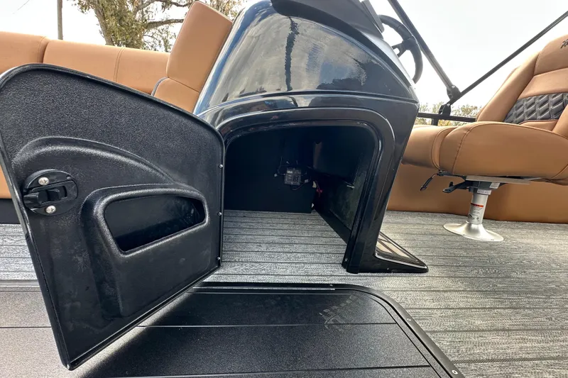 Slide: The Image of 2026 Ranger Reata 223FC boat interior with open storage compartment and tan seating. - 29