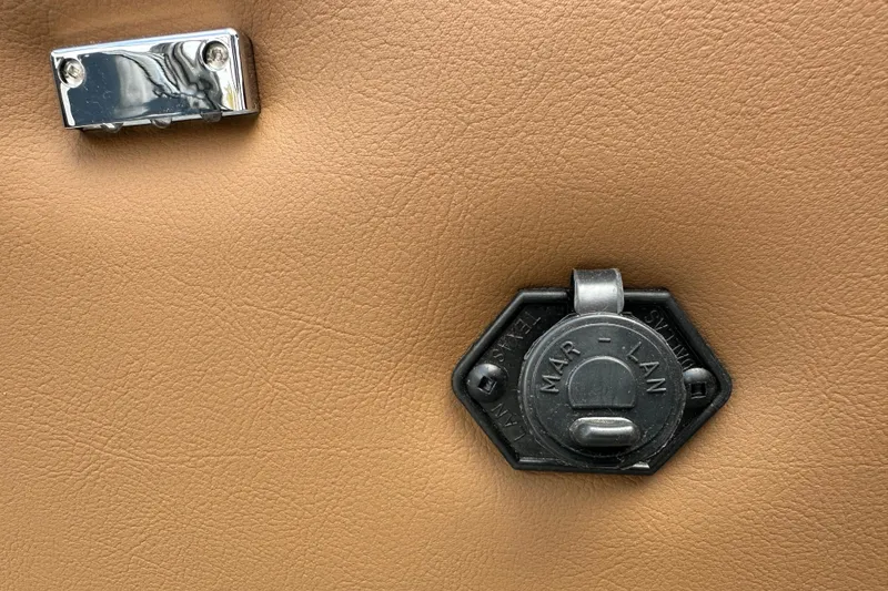 Slide: The Image of 2026 Ranger Reata 223FC interior detail with metal latch on tan surface. - 33