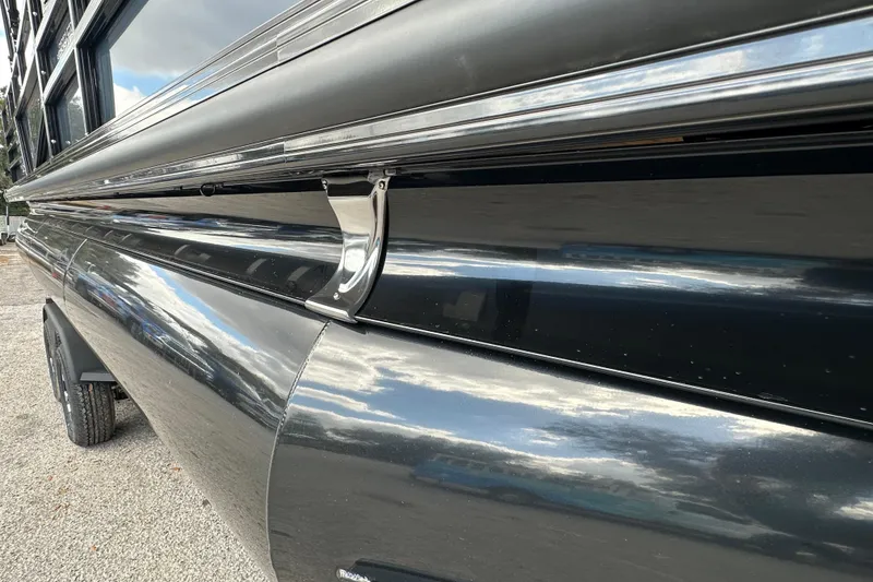 Slide: The Image of 2026 Ranger Reata 223FC boat exterior with sleek black finish and chrome details. - 39