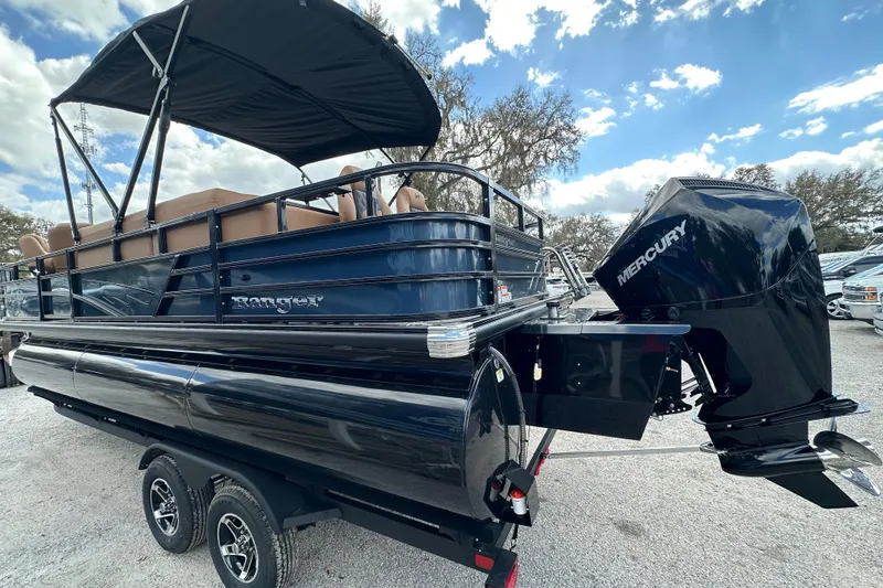 Slide: The Image of 2026 Ranger Reata 223FC pontoon boat with Mercury engine, parked on a trailer. - 41
