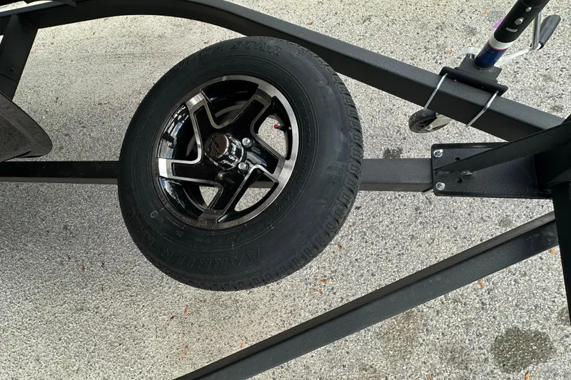 Slide: The Image of 2026 Ranger Reata 223FC trailer wheel on concrete surface. - 46