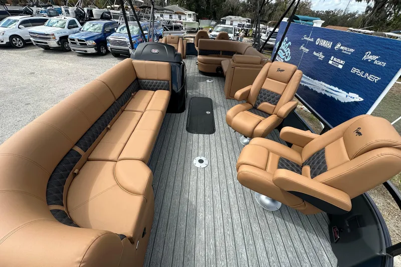 Slide: The Image of 2026 Ranger Reata 223FC boat interior with tan seating and modern design. - 5