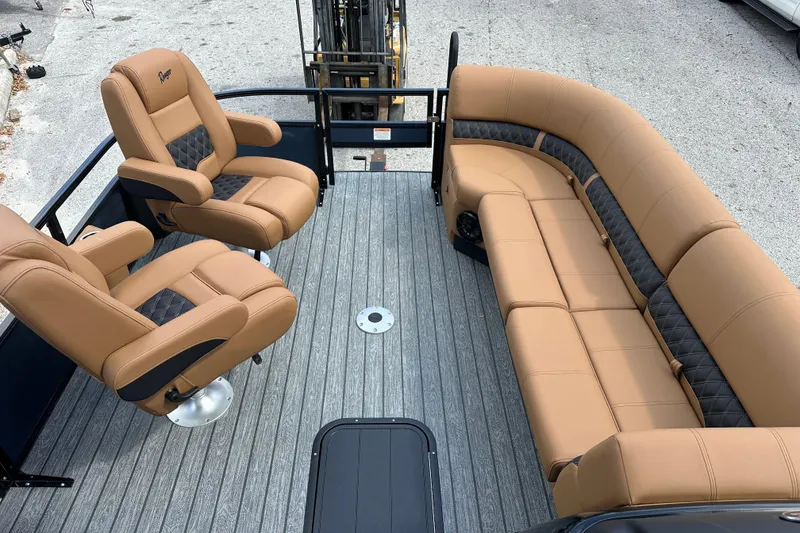 Slide: The Image of 2026 Ranger Reata 223FC boat interior with tan and black seating on gray deck. - 6