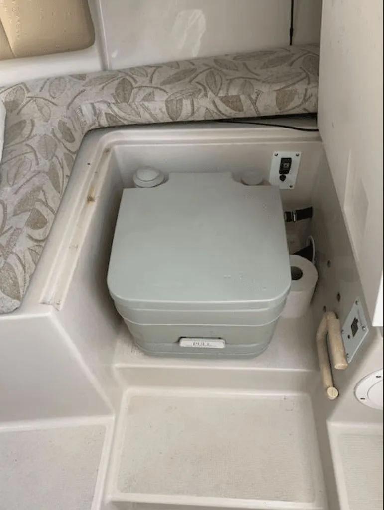 Slide: The Image of Interior of 2005 Robalo R235 WA with portable toilet. - 11