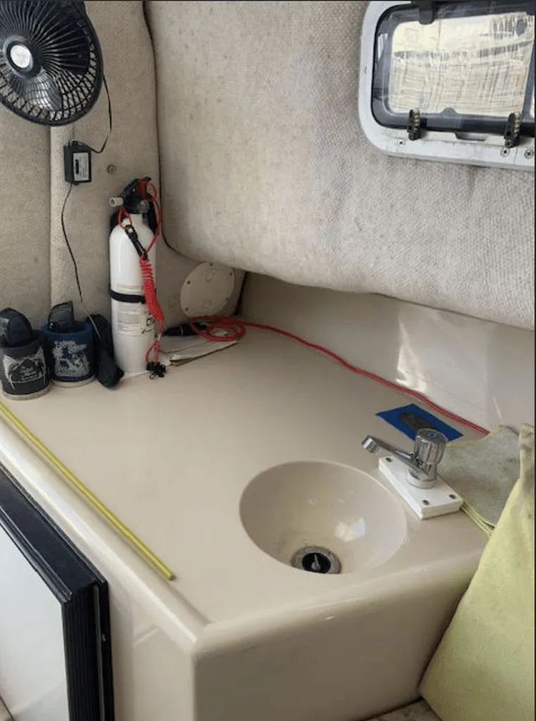 Slide: The Image of Interior of 2005 Robalo R235 WA with sink and fire extinguisher. - 12