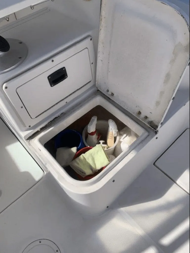 Slide: The Image of Open storage compartment on a 2005 Robalo R235 WA boat. - 14