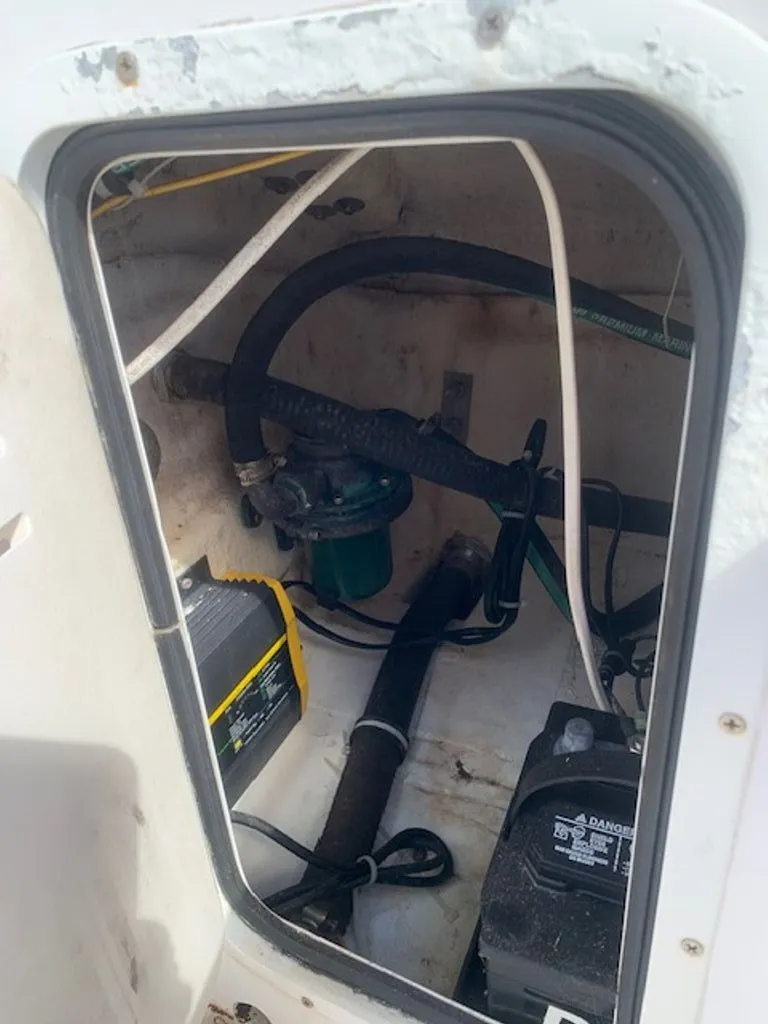Slide: The Image of Interior view of a 2005 Robalo R235 WA boat engine compartment. - 21