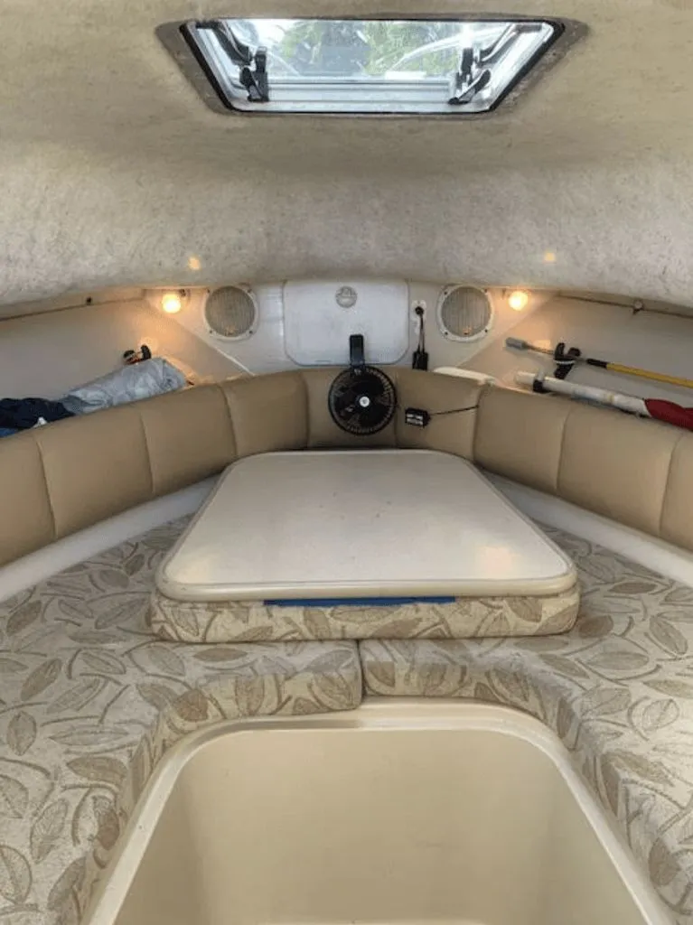 Slide: The Image of Interior of a 2005 Robalo R235 WA with cushions and table. - 9