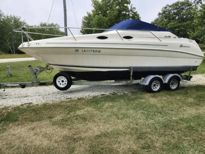 The Image of 1997 Sea Ray 240 Sundancer on trailer, parked on grass. - 0