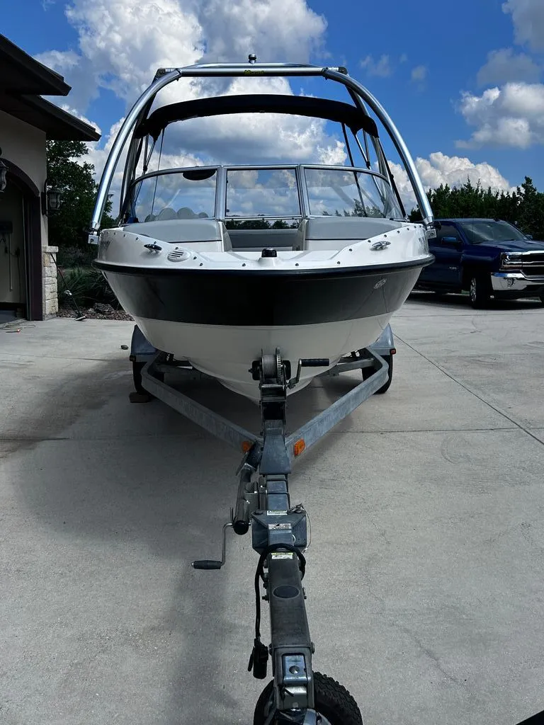 The Image of 2011 Bayliner 185 boat on trailer under blue sky. - 0