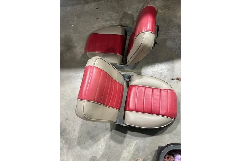 Slide: The Image of 2008 Nitro 189 Sport boat seats, red and beige, on concrete floor. - 11