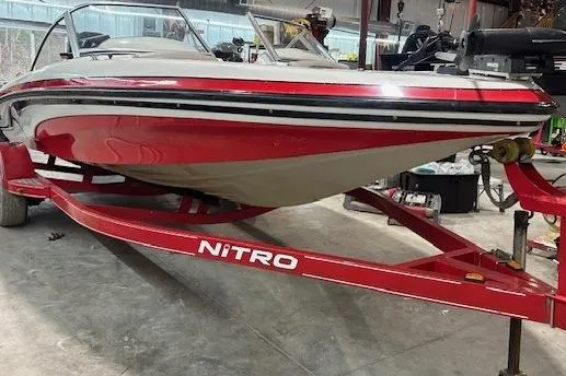 Slide: The Image of 2008 Nitro 189 Sport boat on red trailer in a garage setting. - 3