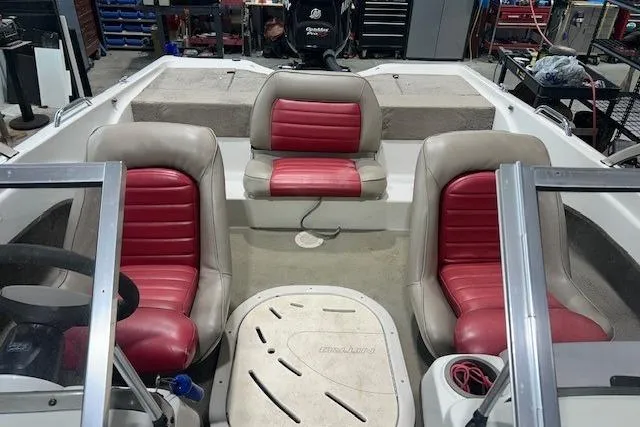 Slide: The Image of 2008 Nitro 189 Sport boat interior with red and beige seating in a workshop setting. - 5
