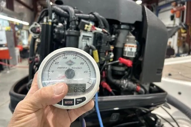 Slide: The Image of Hand holding tachometer in front of 2008 Nitro 189 Sport boat engine. - 7
