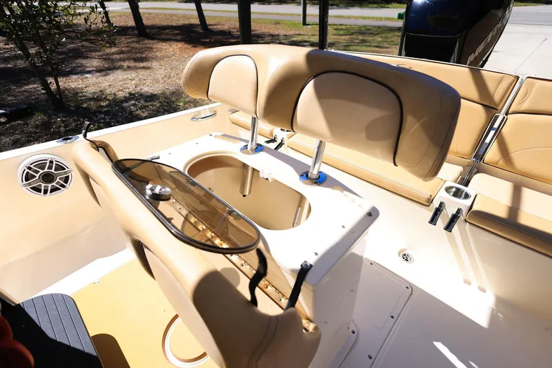 Slide: The Image of 2019 Scout 251 XSS boat interior with tan seating and cup holders. - 14