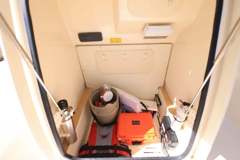 Slide: The Image of 2019 Scout 251 XSS boat interior with beige seating and clear blue sky background. - 22