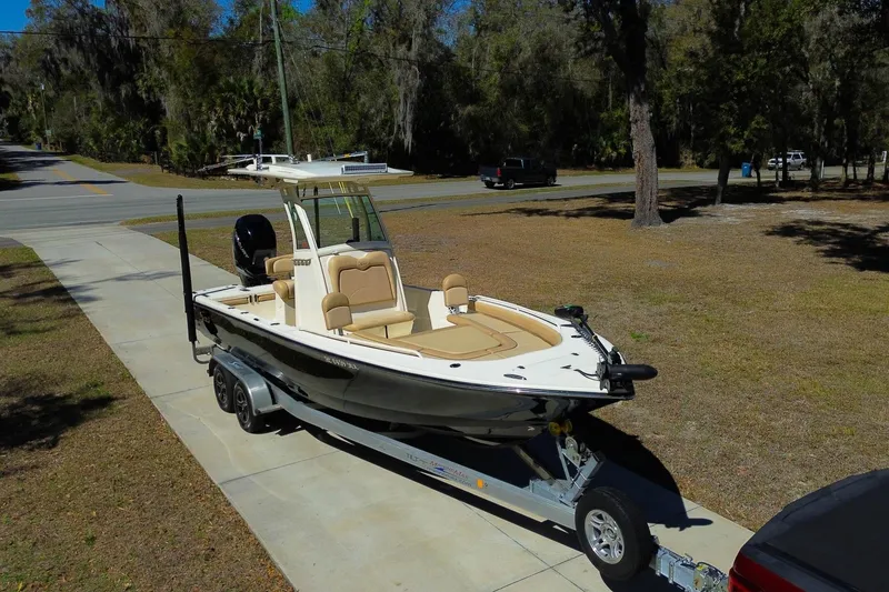 Slide: The Image of 2019 Scout 251 XSS boat on trailer in wooded area. - 28