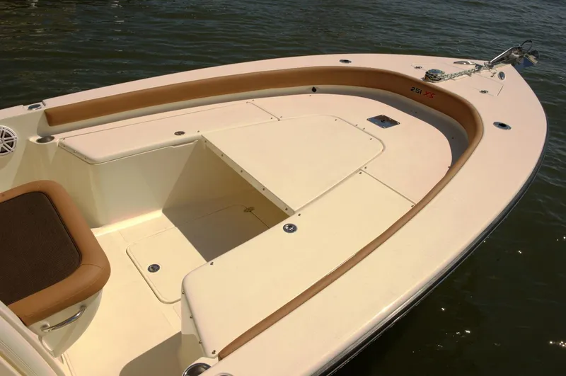 Slide: The Image of 2019 Scout 251 XSS boat on trailer, parked on a sunny driveway. - 3