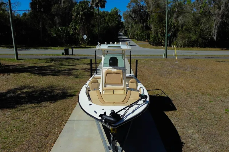 Slide: The Image of 2019 Scout 251 XSS boat on trailer in outdoor setting. - 30