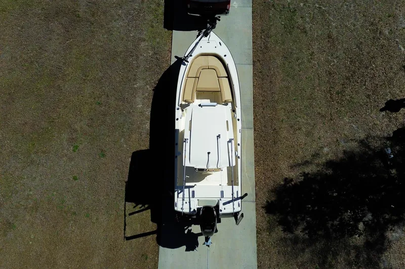 Slide: The Image of 2019 Scout 251 XSS boat with 350 horsepower engine parked in driveway. - 33