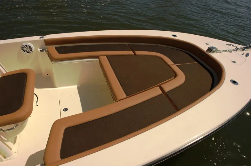 Slide: The Image of 2019 Scout 251 XSS boat on trailer, parked outdoors with trees in background. - 4