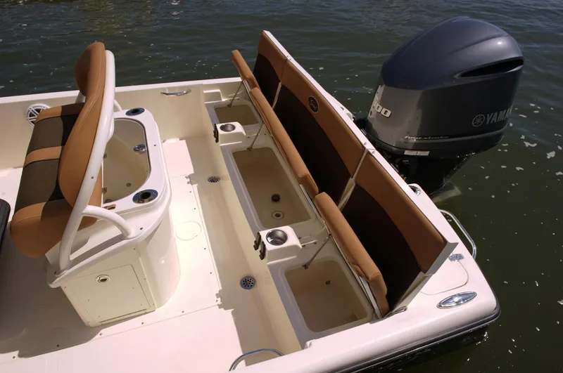 Slide: The Image of 2019 Scout 251 XSS boat interior with tan seating and storage compartment. - 9