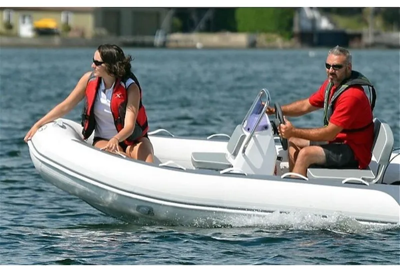 The Image of Two people riding a Gala A330HL boat on the water. - 0