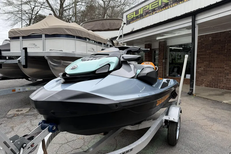 The Image of 2024 Sea-Doo GTI SE 170 jet ski on trailer outside dealership. - 2