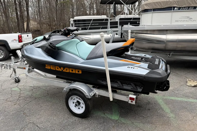 Slide: The Image of 2024 Sea-Doo GTI SE 170 jet ski on trailer, parked outdoors. - 4