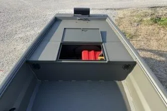 Slide: The Image of 2026 Gator Tail 1748 Gator Series boat with open storage compartment on gravel surface. - 6