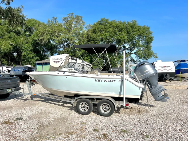 Slide: The Image of 2021 Key West 203 DFS boat on trailer parked outdoors. - 2