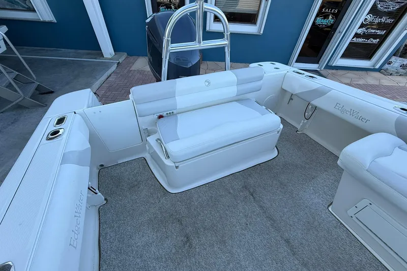 Slide: The Image of 2011 Edgewater 205CX Crossover boat interior with white seating and carpeted floor. - 11