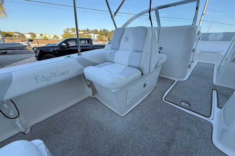Slide: The Image of Interior of 2011 Edgewater 205CX Crossover boat with plush seating and carpeted flooring. - 14