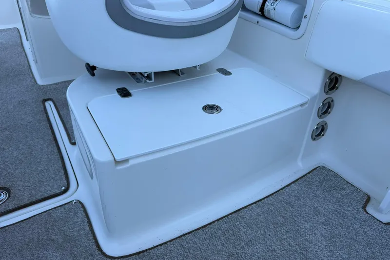 Slide: The Image of Interior of 2011 Edgewater 205CX Crossover boat showing seating and storage area. - 17