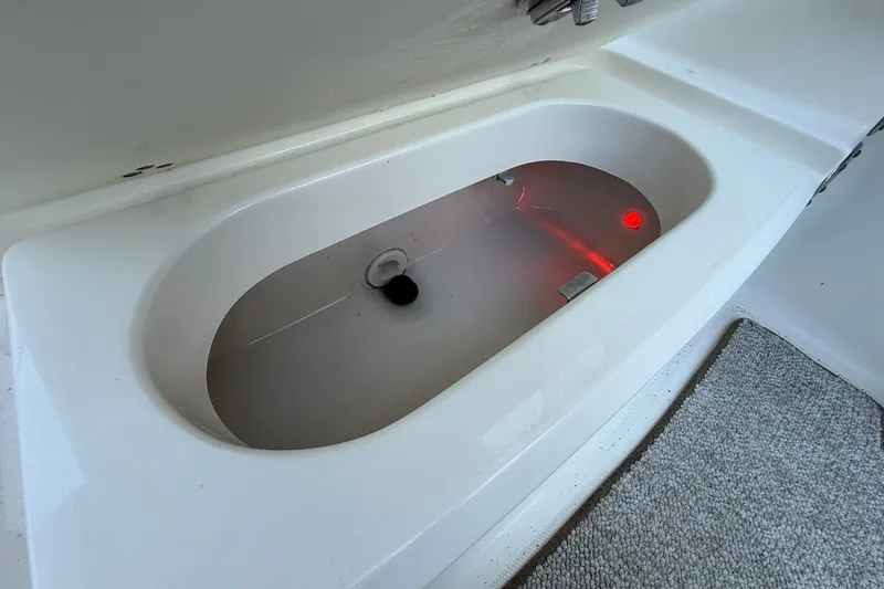 Slide: The Image of Livewell in 2011 Edgewater 205CX Crossover boat, featuring a clean, white interior. - 18