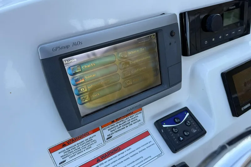 Slide: The Image of Edgewater 205CX Crossover 2011 boat dashboard with Garmin GPSmap 740s and controls. - 22