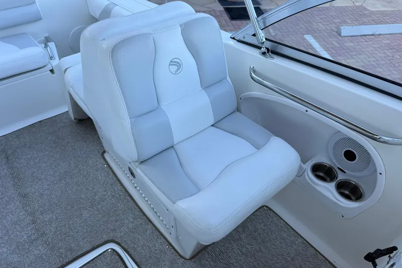Slide: The Image of 2011 Edgewater 205CX Crossover boat interior with cushioned seating and cup holders. - 28